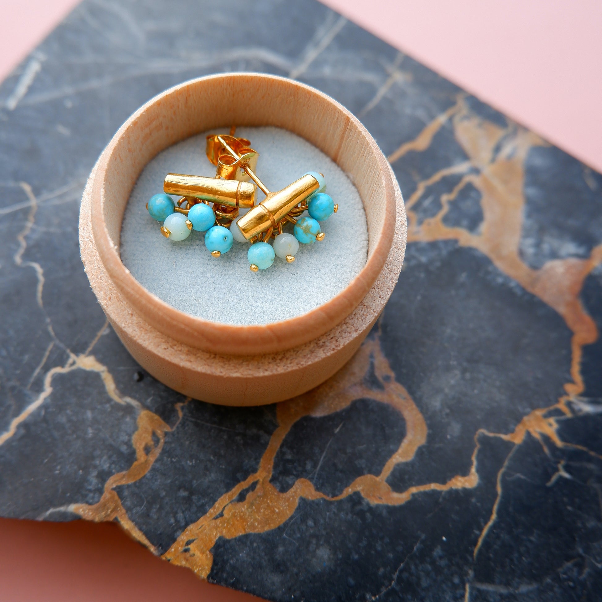 gold vermeil bamboo bar stud earrings with turquoise & blue gemstone beads, in a wooden gift box, on black marble