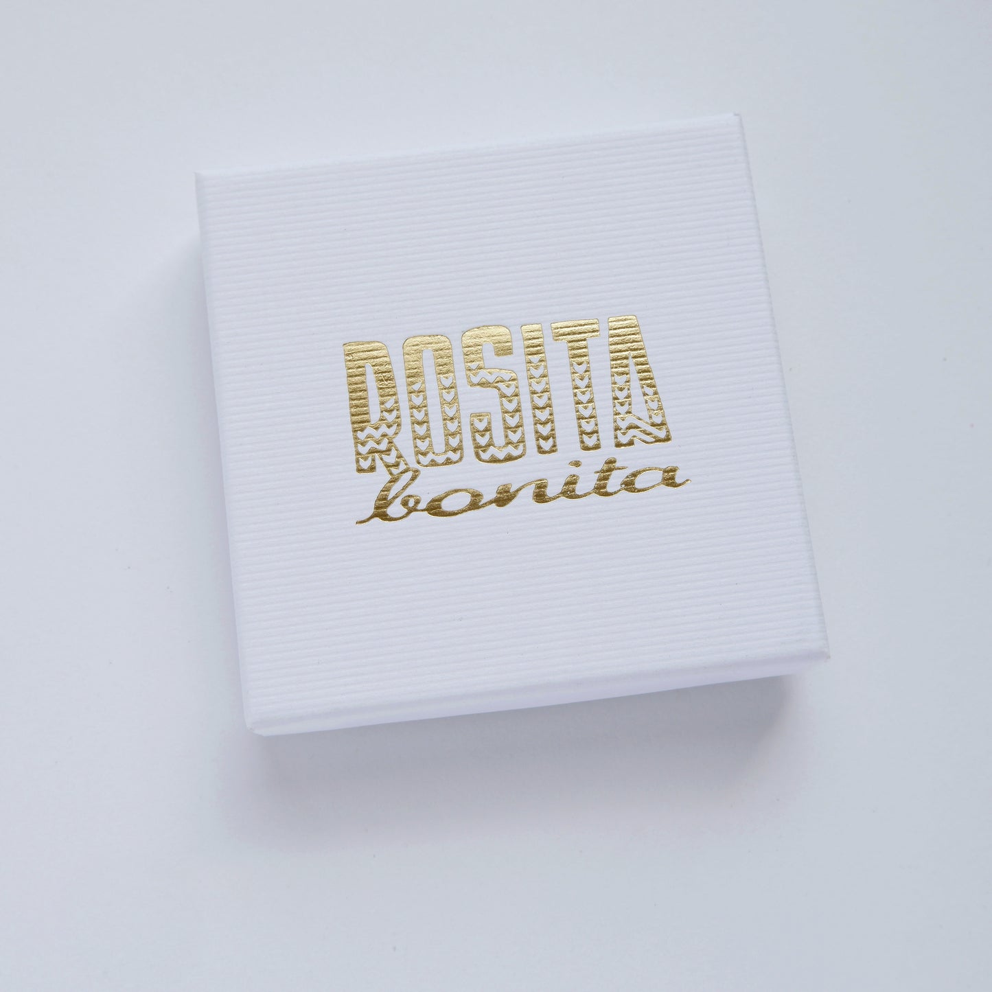 white ribbed cardboard jewellery box with Rosita Bonita logo in gold