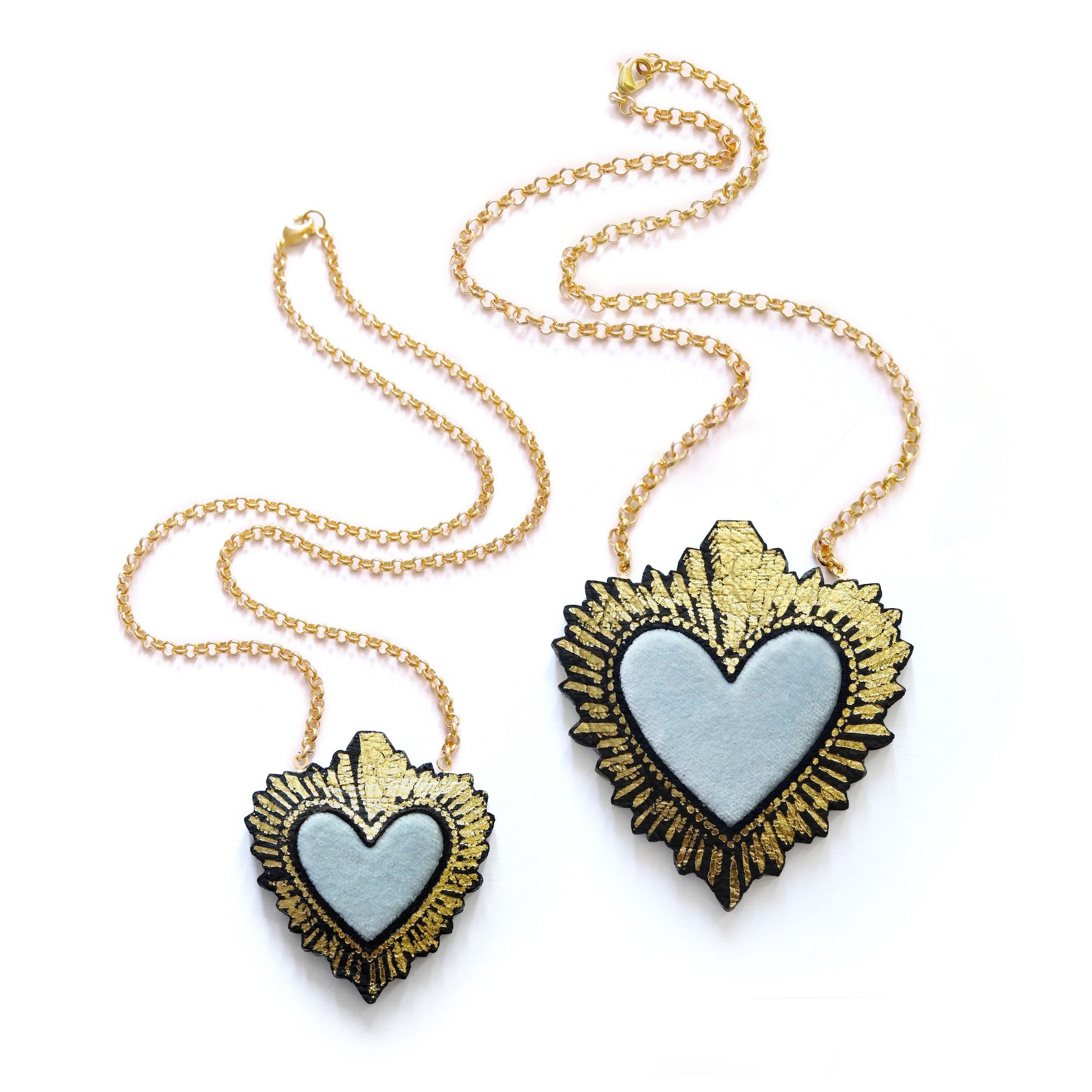 two sizes of pastel blue velvet sacred heart pendant necklace, on gold belcher chain